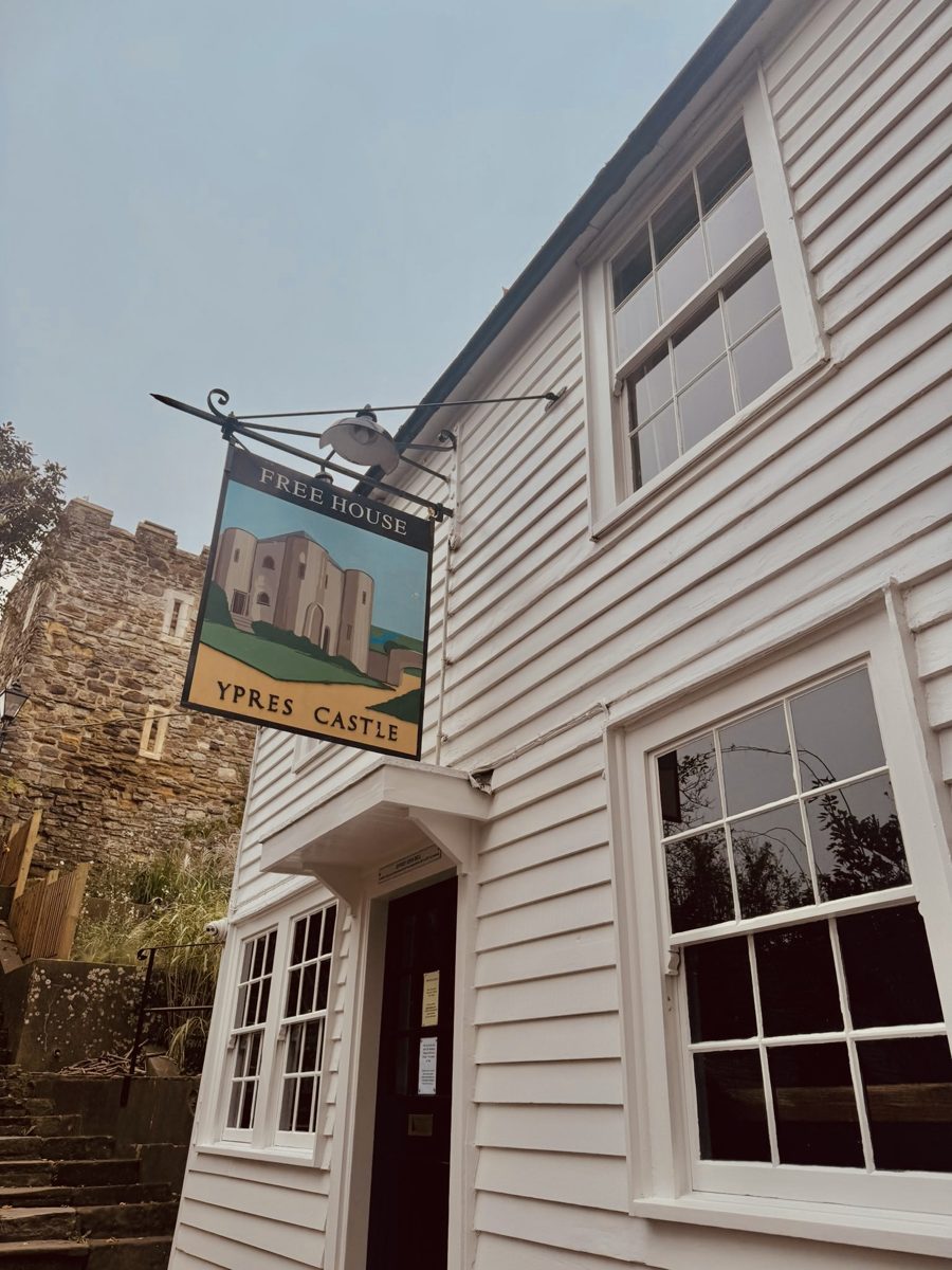 The weatherboarded front of the Ypres Castle Inn, with its hanging sign